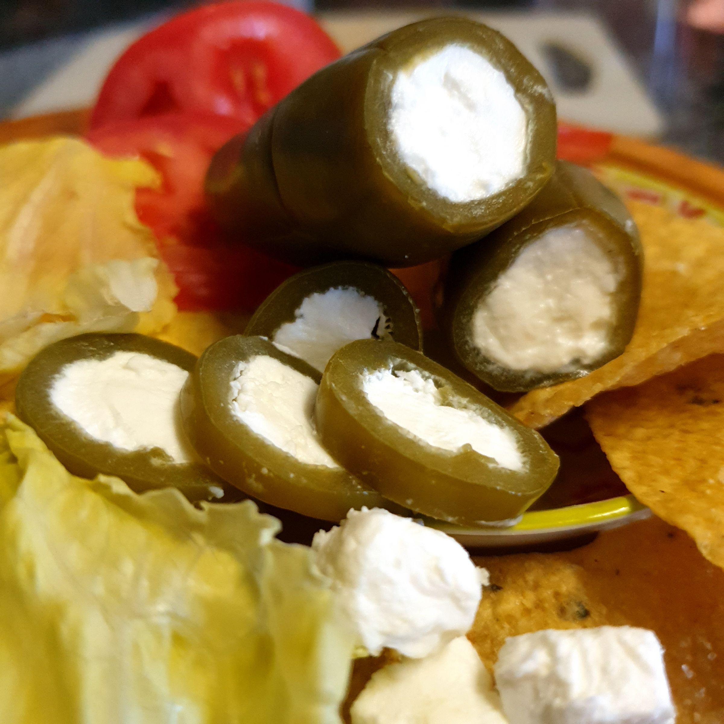 Jalapeños filled with white feta, served with tomato, lettuce and corn chips