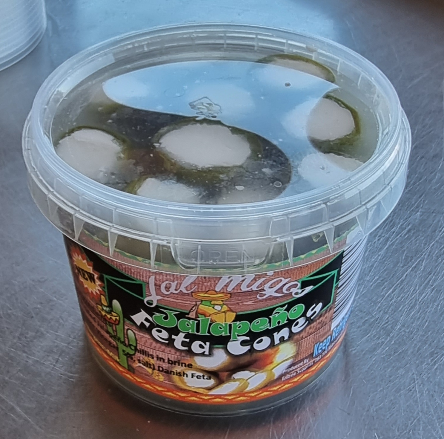 Tub of Jalapeño Feta Cones, with jalapeños and feta visible through the clear lid
