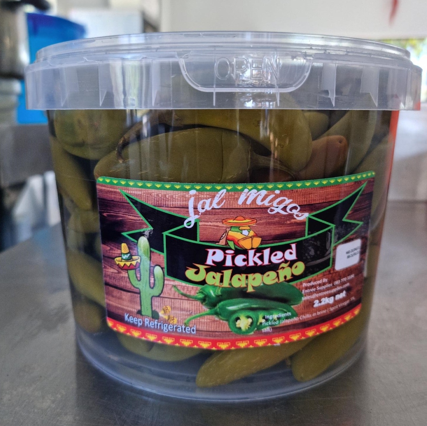 Clear 2.2kg bucket packed with whole pickled jalapeños, with the green and red label